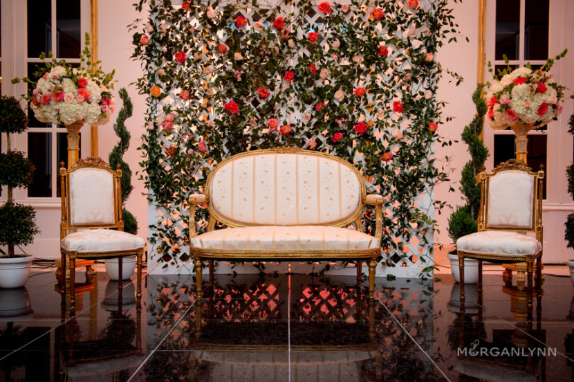 Tamara Menges designed and built the floral backdrop to set the couples stage. She brought the French garden inside using toparies, lattice and greenery galore.