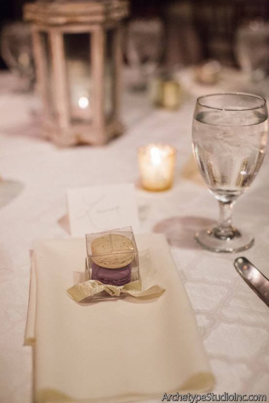 Custom lavender macarons from Macaron by Patisse at each place setting. If you are going to do favors, edible is the way to go to ensure your money doesn't end up in the trash.