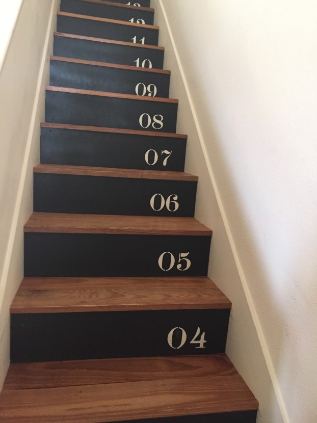 Hand-stenciled and modern stairs leading to the sleeping quarters.